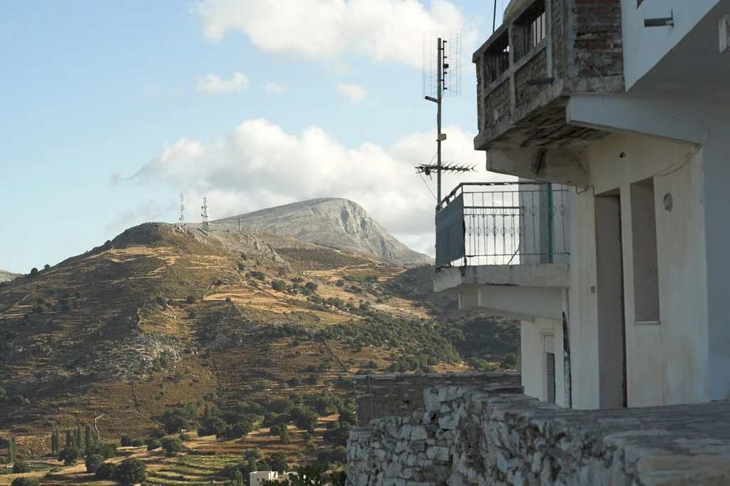 Θέα προς το βουνό Ζας από τις πεζούλες της Απειράνθου, με λόφους, αναβαθμίδες και ένα σπίτι